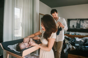 Mother and father taking care of their baby